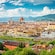 An aerial view of Florence, Italy with a river and mountains in the background